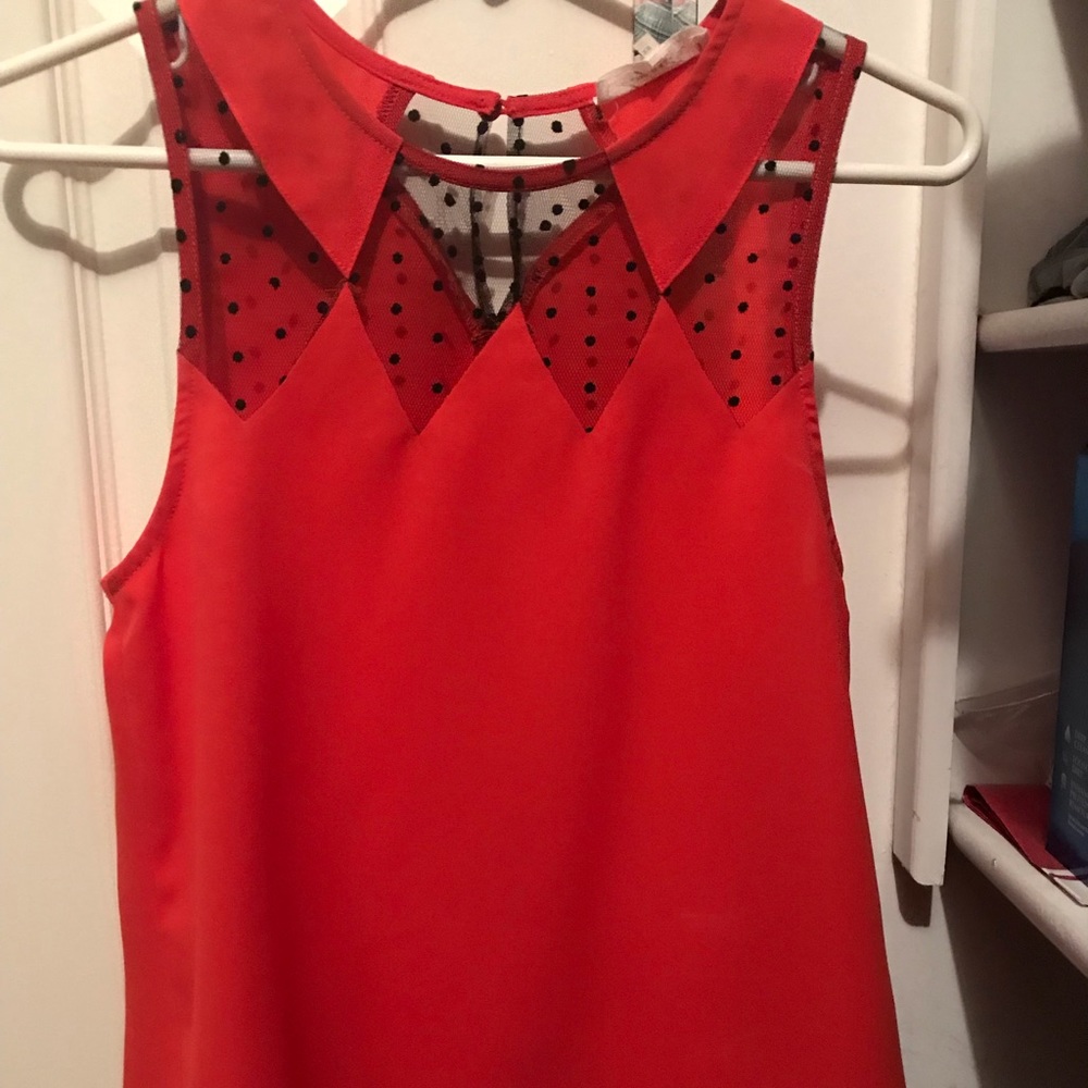 Red blouse with sheer black detail at neckline